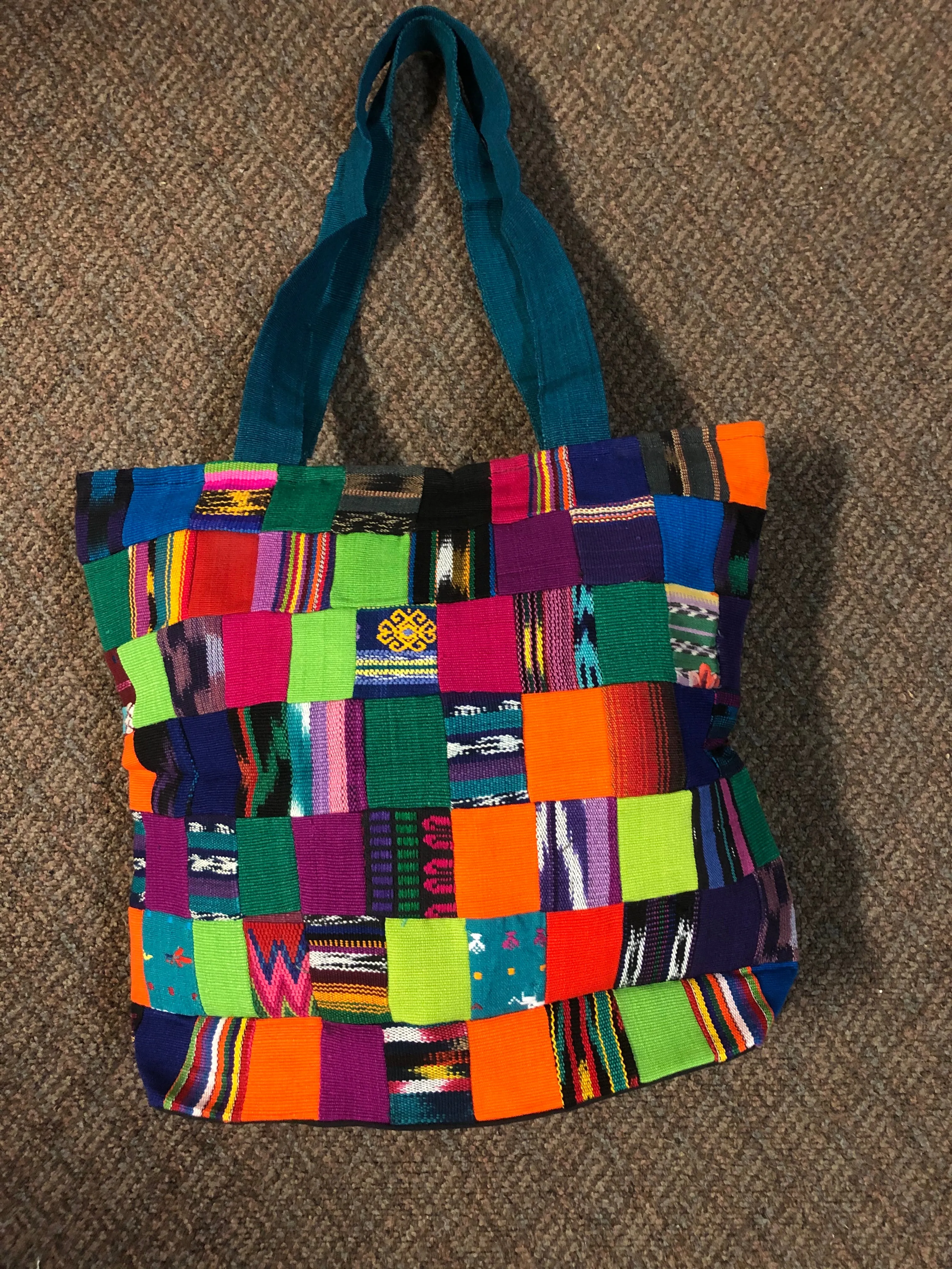 Handwoven Guatemalan cotton patches fashioned into a sturdy shoulder bag, fully lined with one zipper pocket. 15” x 17”